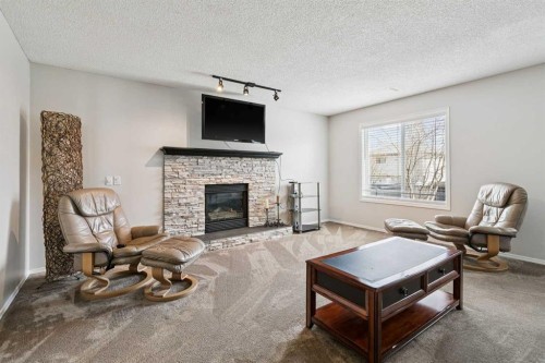 438 Sheep River Point, Okotoks, AB - Indoor Photo Showing Living Room With Fireplace