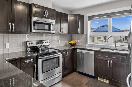 438 Covecreek Circle Ne, Calgary, AB - Indoor Photo Showing Kitchen With Stainless Steel Kitchen With Double Sink With Upgraded Kitchen