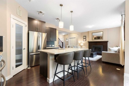 165 Cranarch Common Se, Calgary, AB - Indoor Photo Showing Kitchen With Fireplace With Upgraded Kitchen