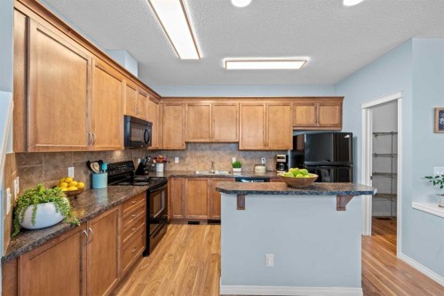 219 New Brighton Landing Se, Calgary, AB - Indoor Photo Showing Kitchen With Double Sink