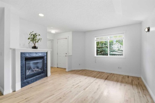 2-435 13 Avenue Ne, Calgary, AB - Indoor Photo Showing Other Room With Fireplace
