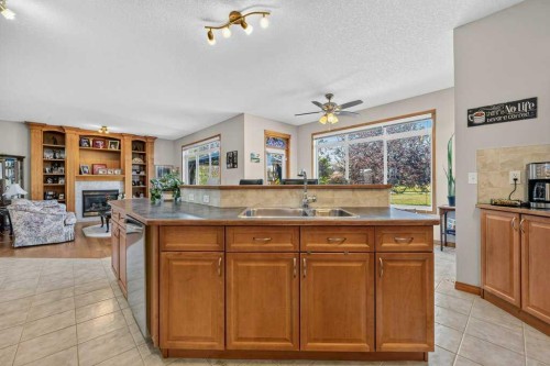 10 Westmount Road, Okotoks, AB - Indoor Photo Showing Kitchen With Fireplace With Double Sink