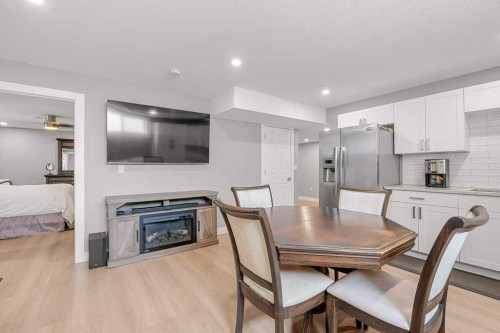 471 Canals Boulevard Sw, Airdrie, AB - Indoor Photo Showing Dining Room With Fireplace