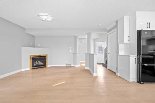 187 Martinvalley Crescent Ne, Calgary, AB - Indoor Photo Showing Other Room With Fireplace
