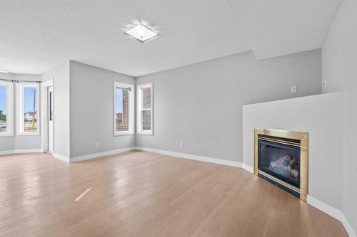 187 Martinvalley Crescent Ne, Calgary, AB - Indoor Photo Showing Living Room With Fireplace