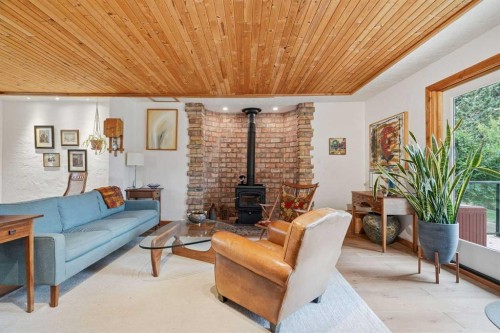 725 Calkins Place, Diamond Valley, AB - Indoor Photo Showing Living Room With Fireplace
