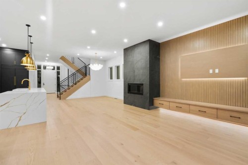 630 27 Avenue Ne, Calgary, AB - Indoor Photo Showing Other Room With Fireplace