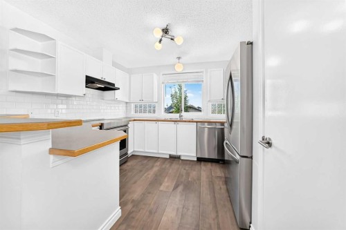 708 Tuscany Drive Nw, Calgary, AB - Indoor Photo Showing Kitchen With Stainless Steel Kitchen With Double Sink With Upgraded Kitchen