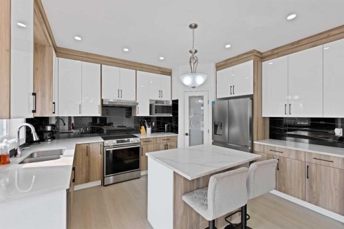 1125 Channelside Drive Sw, Airdrie, AB - Indoor Photo Showing Kitchen With Stainless Steel Kitchen With Double Sink With Upgraded Kitchen