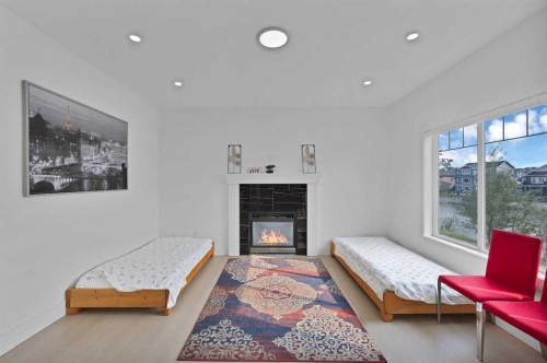 1125 Channelside Drive Sw, Airdrie, AB - Indoor Photo Showing Living Room With Fireplace