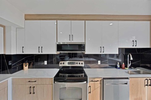 1125 Channelside Drive Sw, Airdrie, AB - Indoor Photo Showing Kitchen With Double Sink