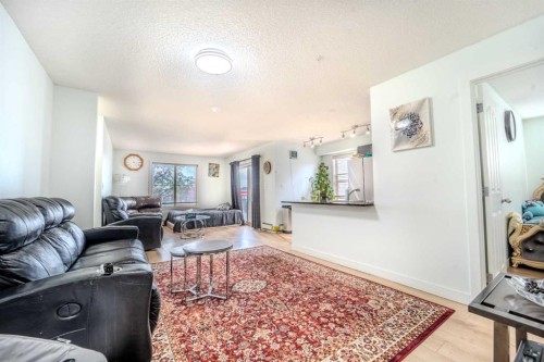 201-7180 80 Avenue Ne, Calgary, AB - Indoor Photo Showing Living Room