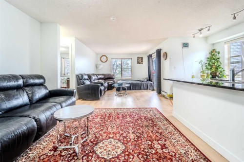 201-7180 80 Avenue Ne, Calgary, AB - Indoor Photo Showing Living Room