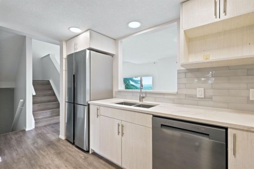 84-5810 Patina Drive Sw, Calgary, AB - Indoor Photo Showing Kitchen With Double Sink With Upgraded Kitchen