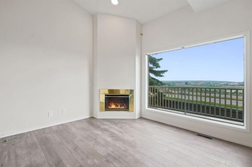 84-5810 Patina Drive Sw, Calgary, AB - Indoor Photo Showing Living Room With Fireplace