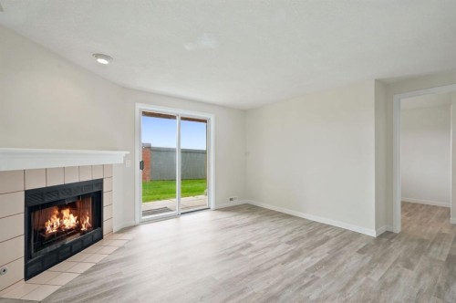 84-5810 Patina Drive Sw, Calgary, AB - Indoor Photo Showing Living Room With Fireplace