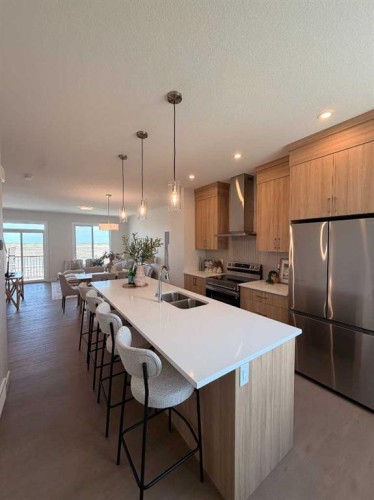 205-4115 206 Avenue Se, Calgary, AB - Indoor Photo Showing Kitchen With Double Sink With Upgraded Kitchen