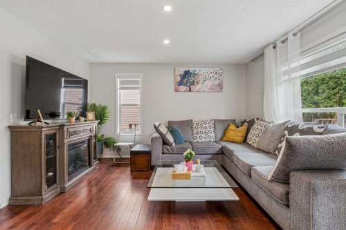 181 Tuscarora Place Nw, Calgary, AB - Indoor Photo Showing Living Room With Fireplace