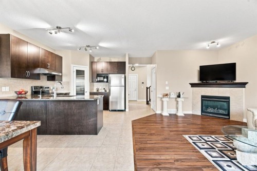 58 Everwoods Park Sw, Calgary, AB - Indoor Photo Showing Kitchen With Fireplace With Stainless Steel Kitchen
