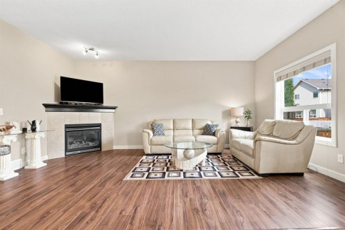 58 Everwoods Park Sw, Calgary, AB - Indoor Photo Showing Living Room With Fireplace