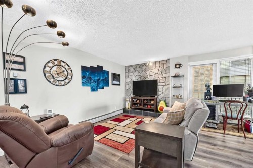 101-300 Meredith Road Ne, Calgary, AB - Indoor Photo Showing Living Room With Fireplace