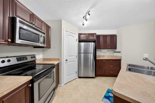 #104-20 Panatella Landing Nw, Calgary, AB - Indoor Photo Showing Kitchen With Stainless Steel Kitchen With Double Sink