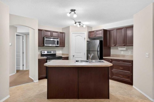 #104-20 Panatella Landing Nw, Calgary, AB - Indoor Photo Showing Kitchen With Stainless Steel Kitchen With Double Sink