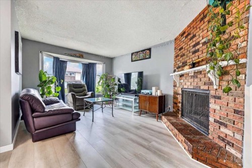 672 Whiteridge Way Ne, Calgary, AB - Indoor Photo Showing Living Room With Fireplace