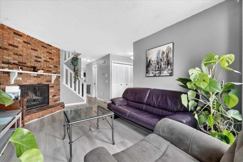 672 Whiteridge Way Ne, Calgary, AB - Indoor Photo Showing Living Room With Fireplace
