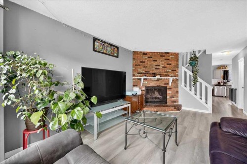 672 Whiteridge Way Ne, Calgary, AB - Indoor Photo Showing Living Room With Fireplace