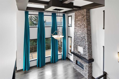 8243 Fortress Drive Sw, Calgary, AB - Indoor Photo Showing Other Room With Fireplace