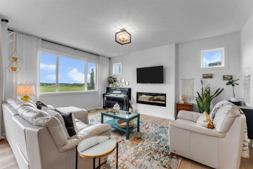 444 Lawthorn Way, Airdrie, AB - Indoor Photo Showing Living Room With Fireplace