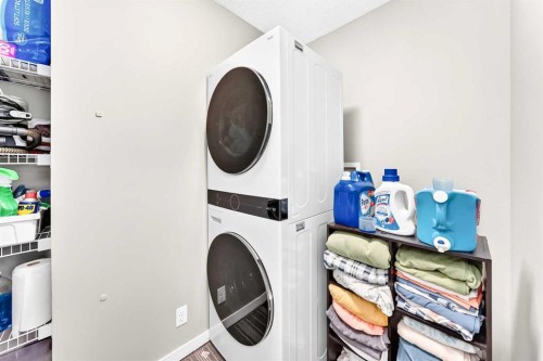 64 Sunset Square, Cochrane, AB - Indoor Photo Showing Laundry Room