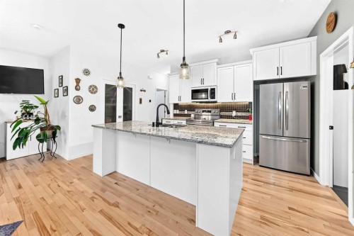 64 Sunset Square, Cochrane, AB - Indoor Photo Showing Kitchen With Upgraded Kitchen