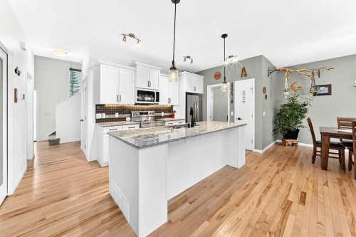 64 Sunset Square, Cochrane, AB - Indoor Photo Showing Kitchen With Upgraded Kitchen