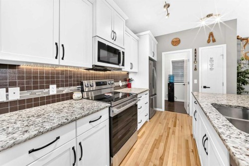 64 Sunset Square, Cochrane, AB - Indoor Photo Showing Kitchen With Double Sink With Upgraded Kitchen