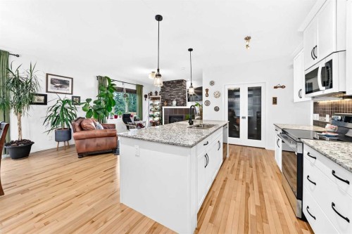 64 Sunset Square, Cochrane, AB - Indoor Photo Showing Kitchen With Upgraded Kitchen