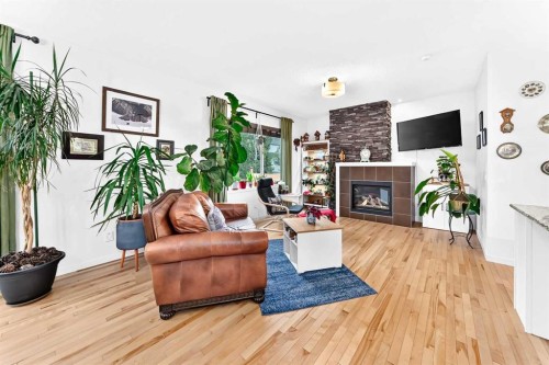 64 Sunset Square, Cochrane, AB - Indoor Photo Showing Living Room With Fireplace