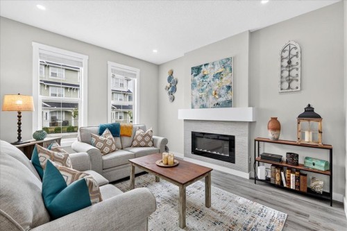 163 Copperleaf Way Se, Calgary, AB - Indoor Photo Showing Living Room With Fireplace