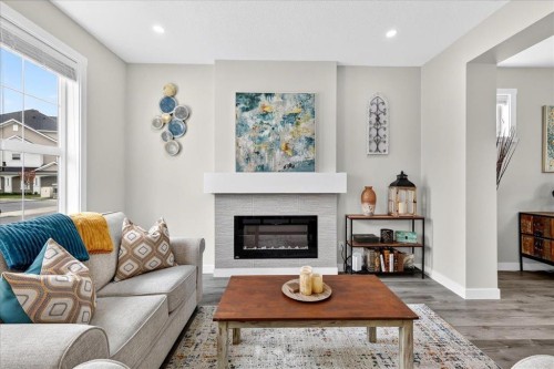163 Copperleaf Way Se, Calgary, AB - Indoor Photo Showing Living Room With Fireplace
