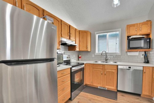 7237 Laguna Way Ne, Calgary, AB - Indoor Photo Showing Kitchen With Stainless Steel Kitchen With Double Sink