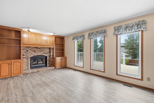 61 Shannon Crescent Sw, Calgary, AB - Indoor Photo Showing Living Room With Fireplace