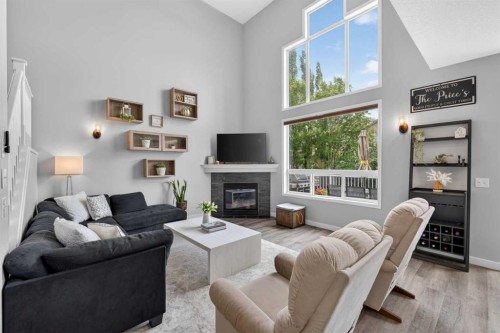 21 Morningside Bay Sw, Airdrie, AB - Indoor Photo Showing Living Room With Fireplace