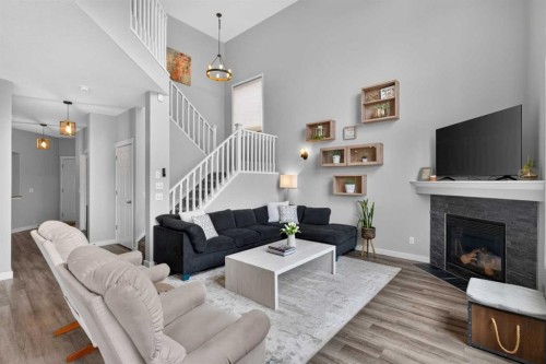21 Morningside Bay Sw, Airdrie, AB - Indoor Photo Showing Living Room With Fireplace