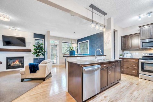13 Cranberry Avenue Se, Calgary, AB - Indoor Photo Showing Kitchen With Fireplace With Stainless Steel Kitchen