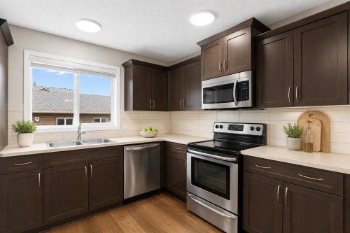 16 Fireside Way, Cochrane, AB - Indoor Photo Showing Kitchen With Double Sink