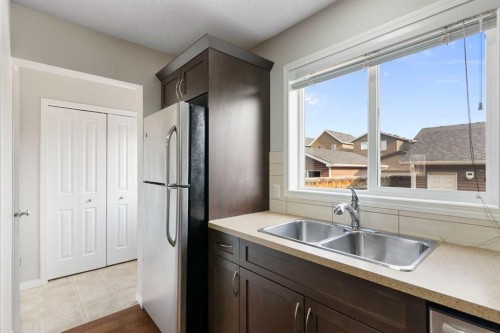 16 Fireside Way, Cochrane, AB - Indoor Photo Showing Kitchen With Double Sink