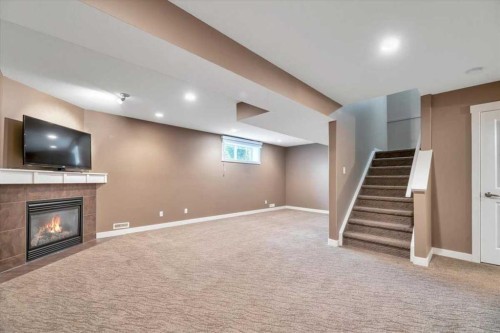 331 Ranch Ridge Meadow, Strathmore, AB - Indoor Photo Showing Basement With Fireplace