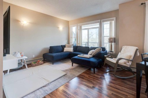 1203-211 Aspen Stone Boulevard Sw, Calgary, AB - Indoor Photo Showing Living Room