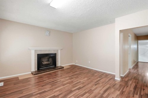 1832 43 Street Se, Calgary, AB - Indoor Photo Showing Living Room With Fireplace